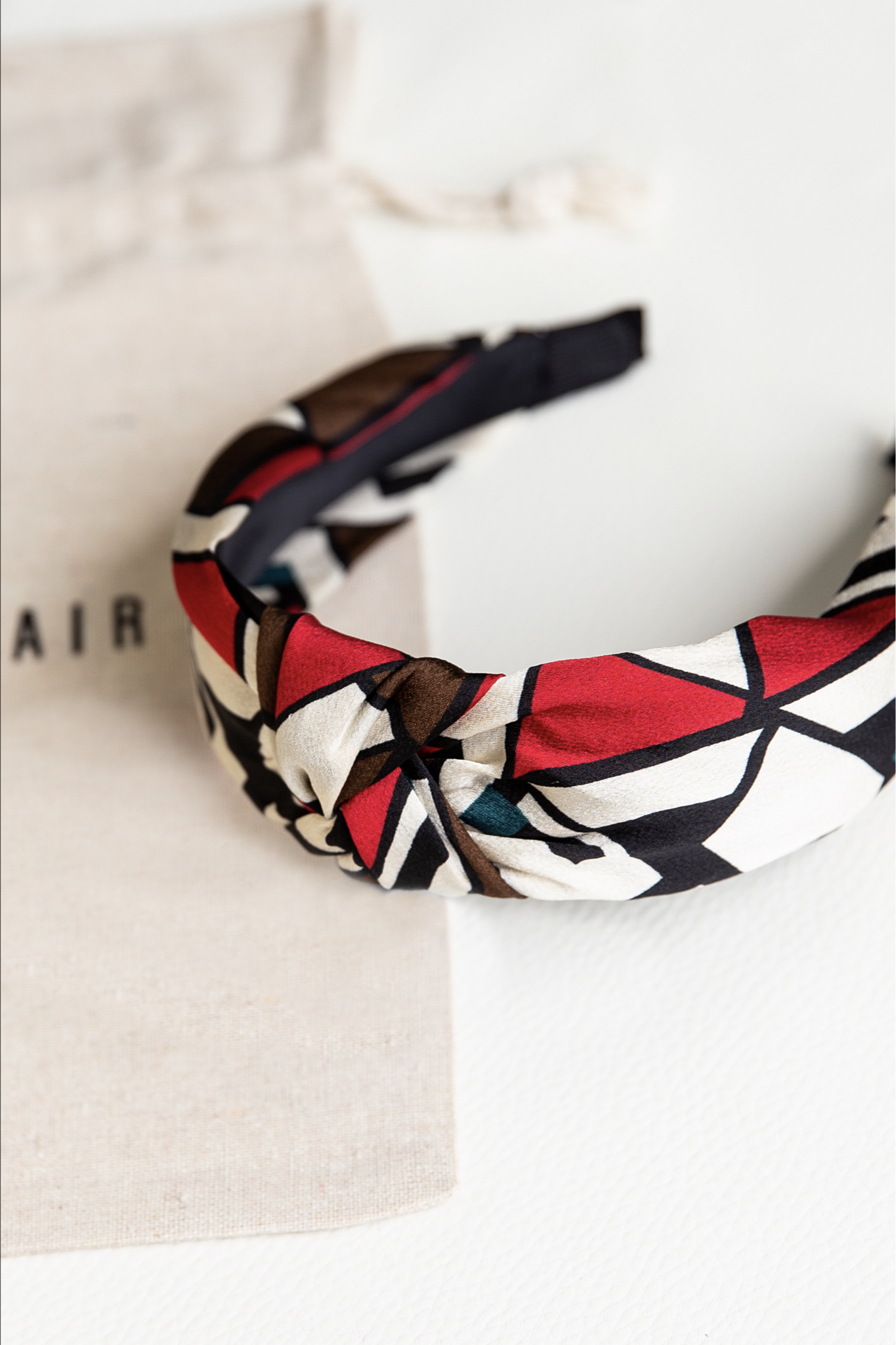 cream and red headband