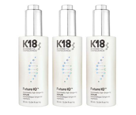 Three white bottles of K18 Biometric Hairscience Future IQ Serum arranged side by side on a plain white background.